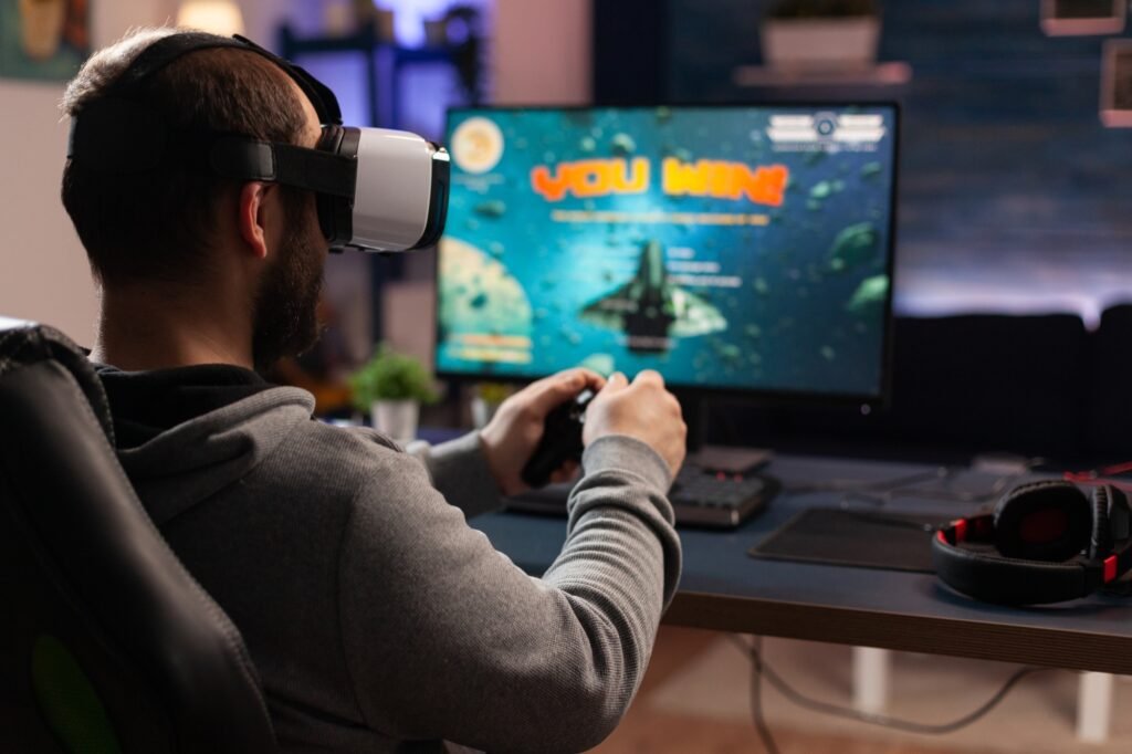 Adult using vr goggles to win video games on computer