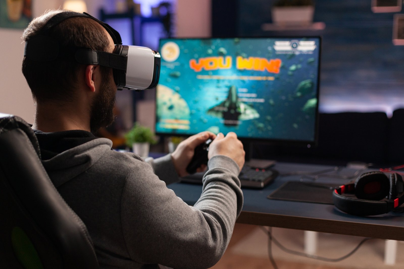 Adult using vr goggles to win video games on computer