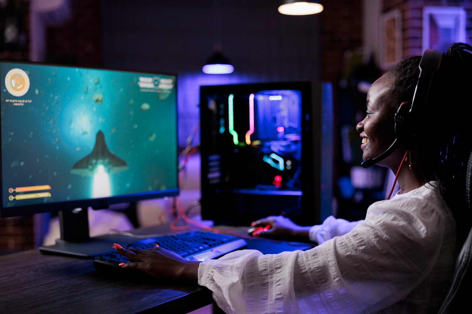 African american woman playing shooting video games on pc