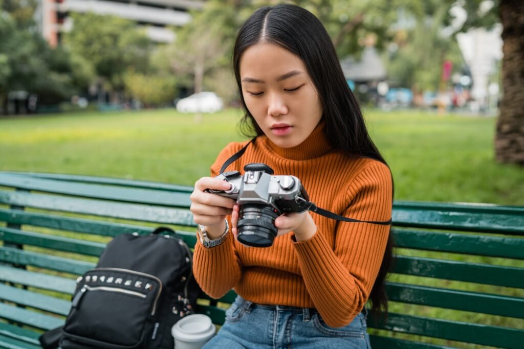 Asian woman using a professional camera.
