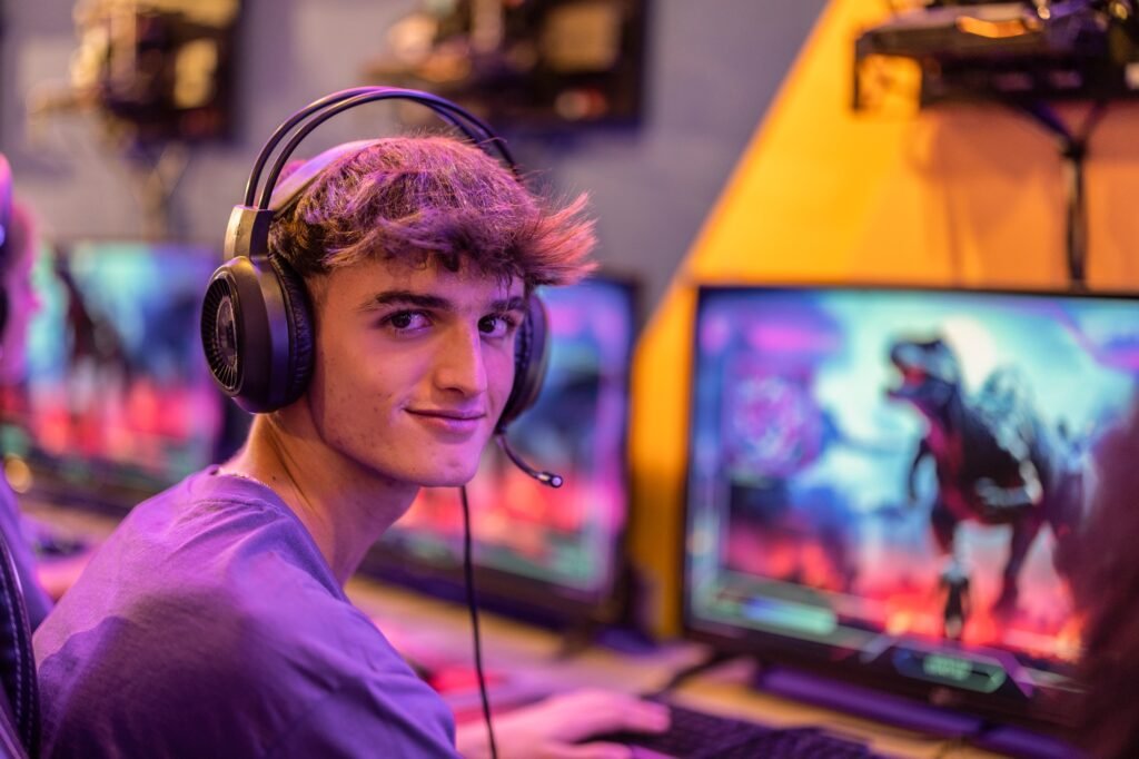 Caucasian man gamer looking at camera while playing video games with compute. gaming club.